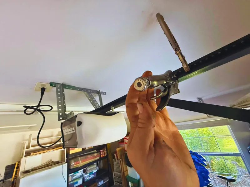 A broken garage door torsion spring — the gap in the coils is the fracture point