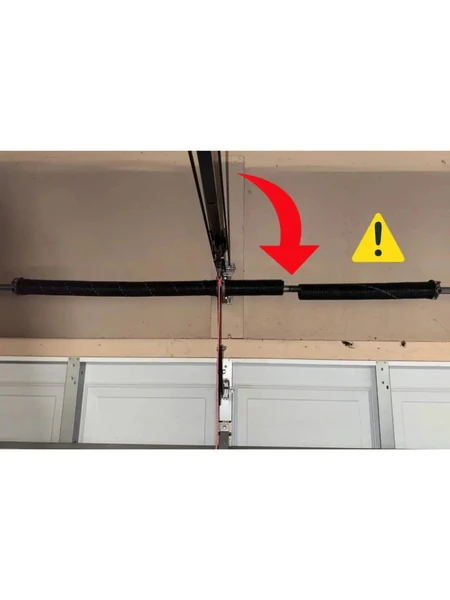 A broken garage door torsion spring — the gap in the coils is the fracture point