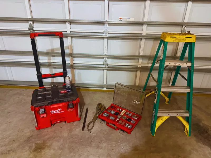Technician performing safety inspection on garage door