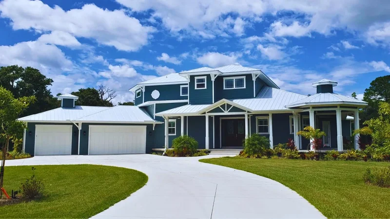 Newly installed white garage doors on a Sarasota-area home